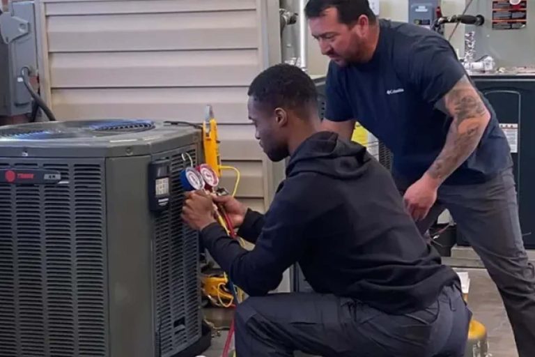 Mentor teaching Mentee HVAC work in class - Heroes United