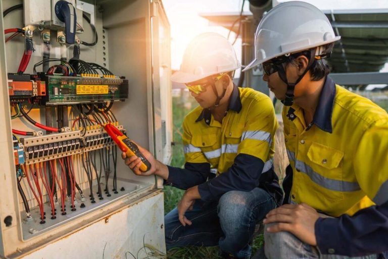 Two students doing electrician work as a trade checking for power - Heroes United