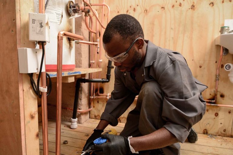 Young Man doing Plumbing work - Heroes United